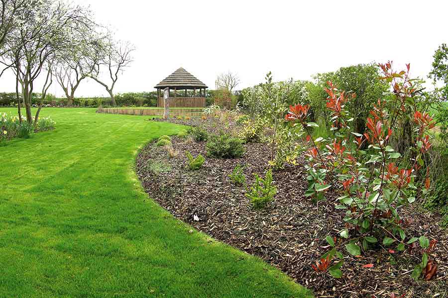 Melcourt bark chippings preventing weed growth in a large flower bed